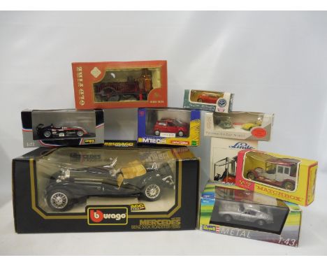 A Burago Mercedes roadster, an onyx Panoz and eight other boxed vehicles, various scales.