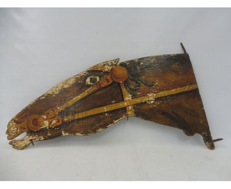 An original circa 1920s/1930s painted wooden frightened horse head, double sided with metal mounting bracket to one end, 30 x