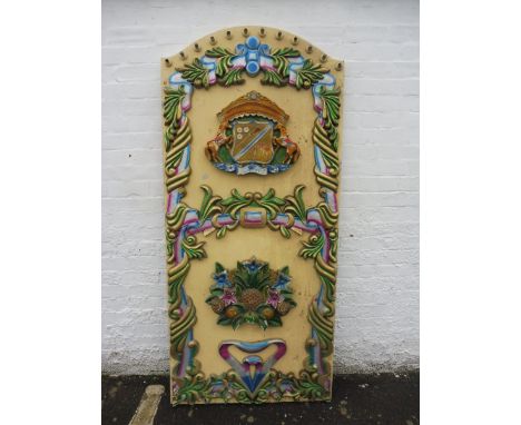 An original centre panel from a fairground carousel ride, with original light fittings to the edge, and carved panels to feat