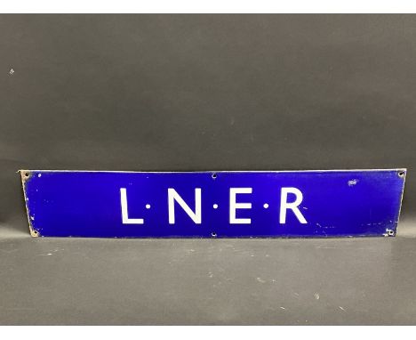 An L.N.E.R. railway dark blue enamel sign in excellent condition, 28 1/2 x 5 3/4".