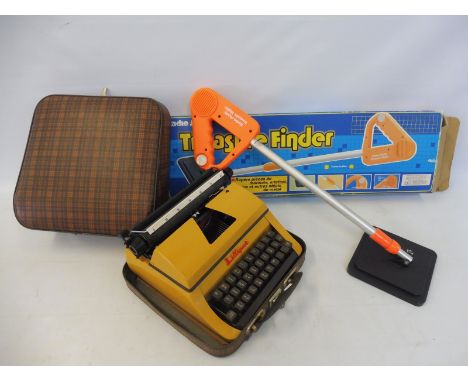 A radio shack metal detector and a typewriter.