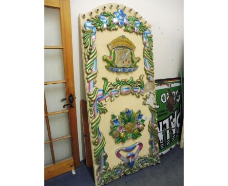 An original centre panel from a fairground carousel ride, with original light fittings to the edge, and carved panels to feat