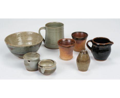 * Leach Pottery. A porcelain cruet set, circa 1950s, comprising of an open salt pot, pepper pot and lidded mustard pot, mottl