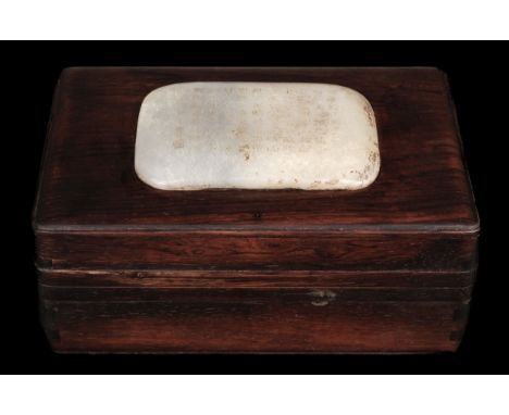 * Jade. A Chinese hardwood box, the lid inset with a large jade panel with 11 rows of calligraphy, the panel measuring 7 x 10