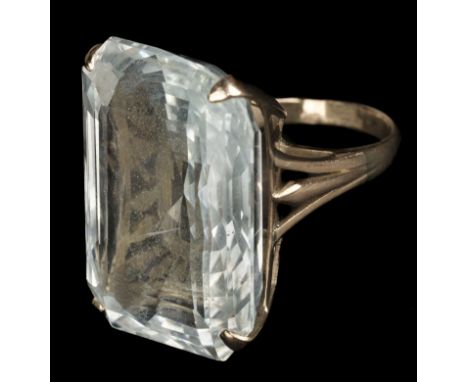 * Ring. A 14ct gold ring, set with a large facet cut pale blue topaz, the stone measures approximately 18 x 20 x 30 mm, ring 