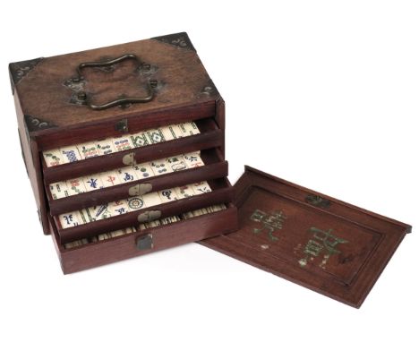 * Mahjong. A Chinese mahjong set, early 20th century, the hardwood box with two carrying handles and fret-cut corners, the sl