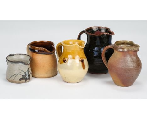 * Studio Pottery. A collection of jugs, including a Lowerdown Pottery stoneware jug, decorated with foxglove motif on grey gr