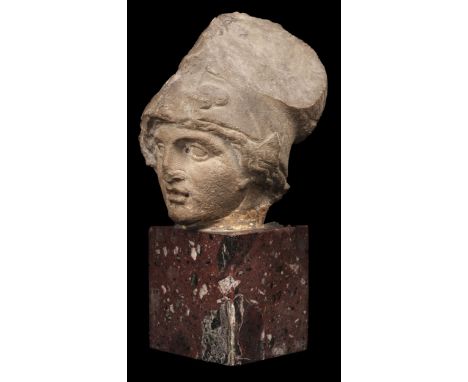 * Roman School. A Roman stone head of Athena, circa 2nd century AD, finely carved stone, with wavy hair to each side of her h