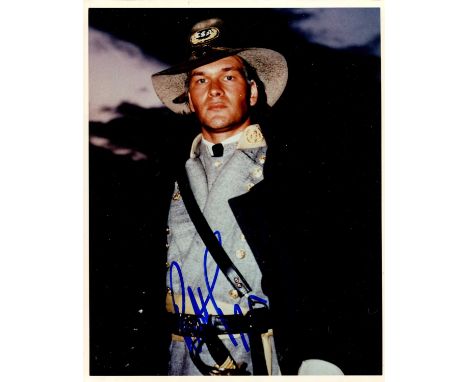 SWAYZE PATRICK: (1952-2009) American actor. Signed colour 8 x 10 photograph of Swayze standing in a half-length pose in unifo