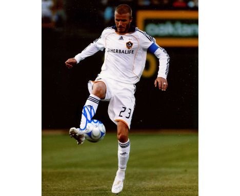BECKHAM DAVID: (1975- ) English Footballer. Signed colour 8 x 10 photograph showing Beckham in a full length action pose wear