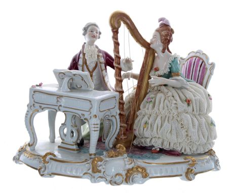 Unterweissbach porcelain figural group interior scene,&nbsp;a lady playing a harp and a gentleman at a spinet, upon an oval b