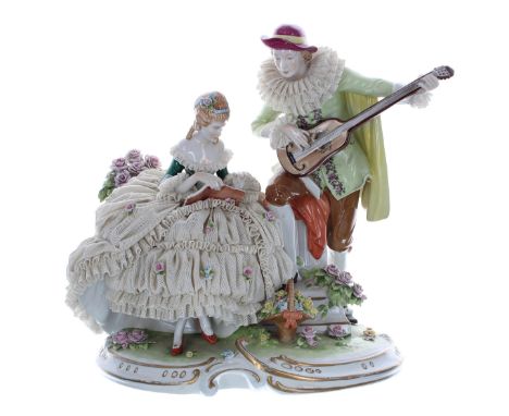 Unterweissbach porcelain figural group of a seated lady in a simulated net crinoline dress, a gentleman wearing a ruff playin