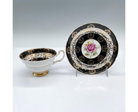 English tea cup and saucer set. Beautifully decorated in black and white bands, and gilded floral overlay. A pink rose featur