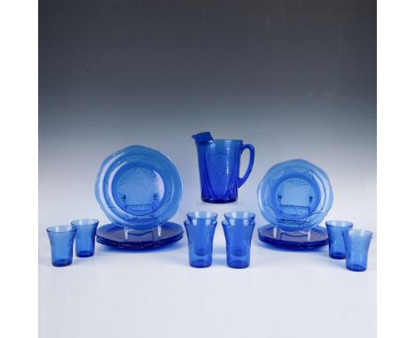 Blue depression glass decorated with lacey floral motifs. Includes 4 luncheon plates, 4 dinner plates, 4 five ounce flat tumb