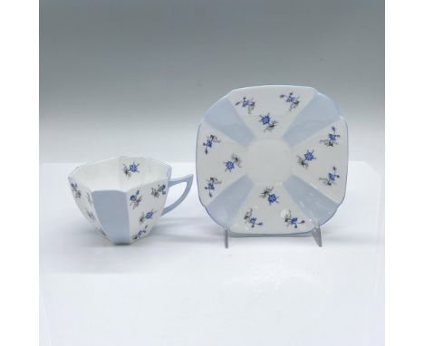 English white and blue tea cup and saucer set adorned with blue petal flowers. Blue trim accents. Shelley backstamps. Cup: 4.