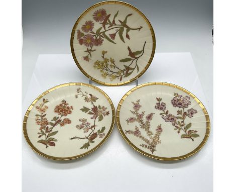Plates decorated with floral and vine design colored in purple, red, green and pink with gilt accents and rim. Royal Worceste