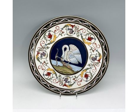 Interesting decorative plate featuring a swan holding a bow while looking down at the arrows. The border features flowers in 