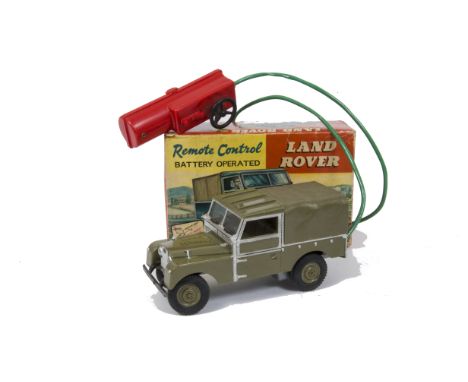 A Marx Toys Remote Control Land Rover, battery operated in dark green with black bumper, silver trim and red remote, in origi