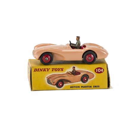 A Dinky Toys 104 Aston Martin DB3S, salmon pink body, red interior and ridged hubs, grey driver, in original box with correct