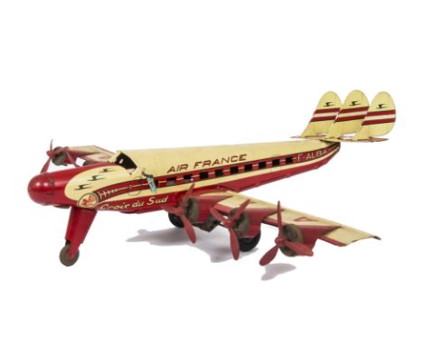 A Joustra France tin Croix du Sud Air France clockwork and electric Airplane, in cream and red with clockwork forward motion 