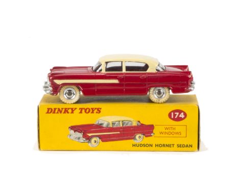 A Dinky Toys 174 Hudson Hornet Sedan, red lower body, cream roof and side flashes, spun hubs, in original box, E, box VG 