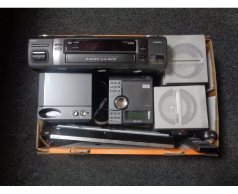 A box containing electricals to include Onn Blue ray player with remote, Aiwa VCR with remote, Bench Micro Hi-Fi system.  