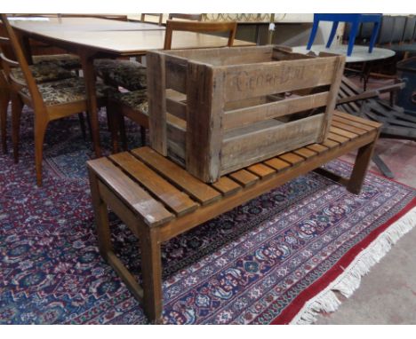 A vintage wooden crate together with a slatted wooden bench 
