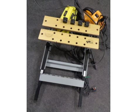 A folding work bench together with a box containing Performance reciprocating saw and two pressure washers. 