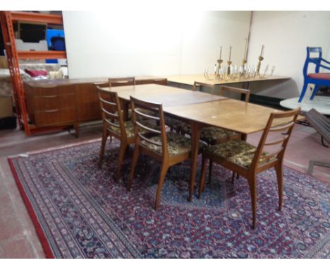 A mid 20th century teak McIntosh furniture eight piece dining room suite comprising of triple door low sideboard, extending d