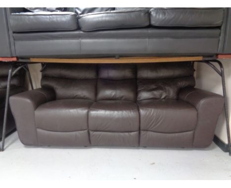 A brown leather manual reclining three seater settee with matching two seater settee.  