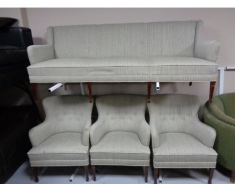 A 20th century three seater settee upholstered in a green corded fabric on mahogany legs together with three matching button 