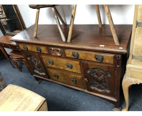 An Art Nouveau mahogany and walnut sideboard with brass drop handles.  