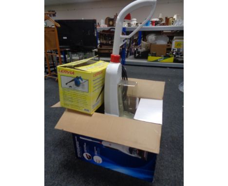 A boxed Bissell compact carpet cleaner together with a further boxed hand held steam cleaner and an angle poise floor lamp.  