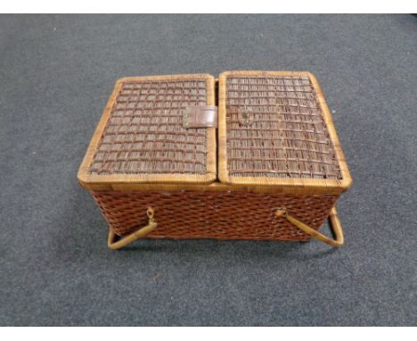 A wicker twin-handled picnic hamper 