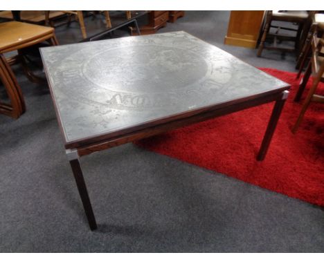 A mid 20th century square Danish coffee table with an etched metal panel top.  