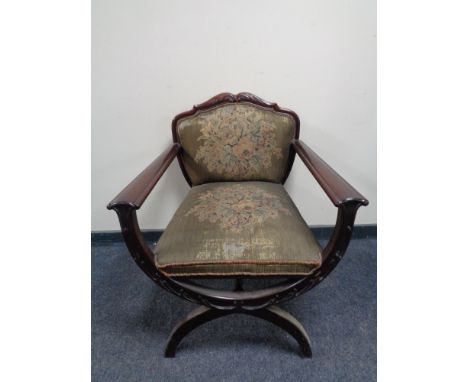 An early 20th century mahogany framed armchair on X-frame support upholstered in a  tapestry fabric.  