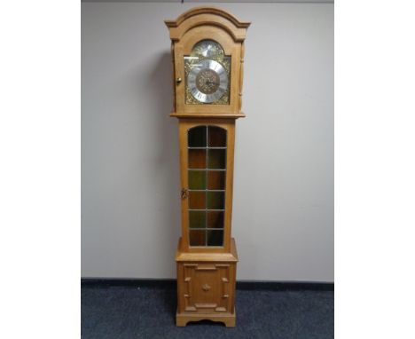 A Tempus Fugit blonde oak longcase clock with pendulum and weights.  