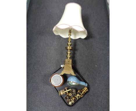 A tray of a large brass table lamp with shade, ship in light bulb, treen biscuit barrel, brass ornaments etc 