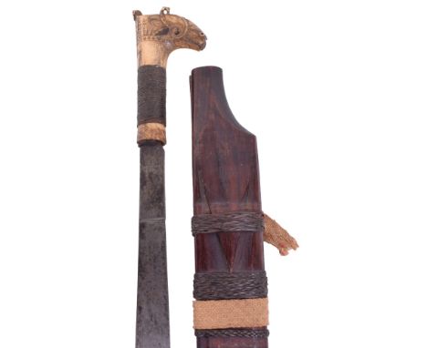 19th Century Borneo Head Hunters Sword Mandau, slightly curved heavy single edge blade cut with wavy design towards the swoll