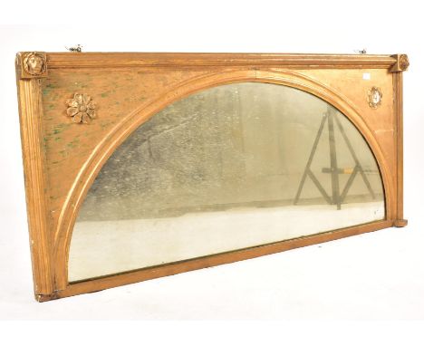A 19th century gilt wood arched overmantel window mirror. Low and wide, the gilt wood and gesso frame with a central arched m
