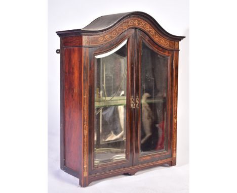 A 20th century Edwardian inlaid rosewood hanging display cabinet. The cabinet having an arched top with inlaid and stencilled