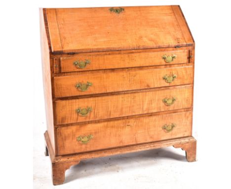 A mid 19th century American tiger maple bureau writing desk. The bureau having a fall front top section with full appointed i