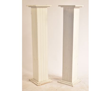 A pair of 20th century neo classical revival painted wooden plant stands / bust stands. Each of reeded square upright form wi