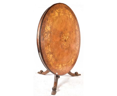 A 19th century Victorian walnut and marquetry inlaid loo table. The table having a large circular top with central inlaid flo