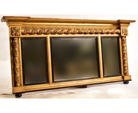 A 19th century giltwood and gesso work overmantle wall mirror. The mirror having barley twist columns under flared pediment t