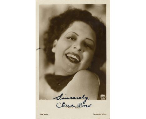 BOW CLARA: (1905-1965) American Actress. Vintage signed sepia postcard photograph of The It Girl in a smiling head and should