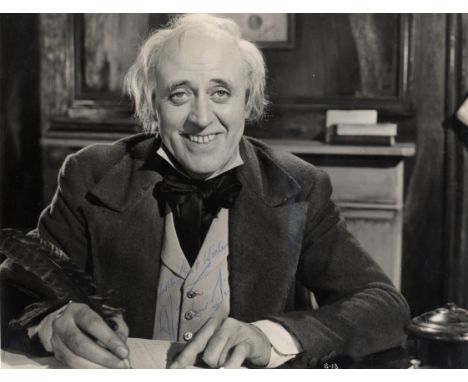 SIM ALISTAIR: (1900-1976) Scottish Character Actor. A good vintage signed 7.5 x 9.5 photograph of Sim seated in a half length