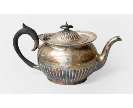 A Victorian Silver Teapot, by Job Frank Hall, London, 1893, oval and with fluted lower body, engraved with a crest, with ebon