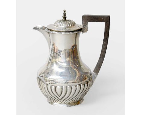 An Edward VII Silver Hot-Water Jug, by Williams Ltd., Birmingham, 1901, tapering and with spiral-fluted lower body, with ebon