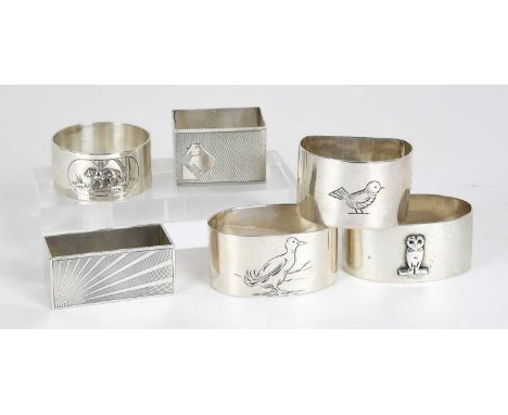 Six Assorted Silver Napkin-Rings, one applied with a bear in high relief; another applied with an owl in high relief; two eng